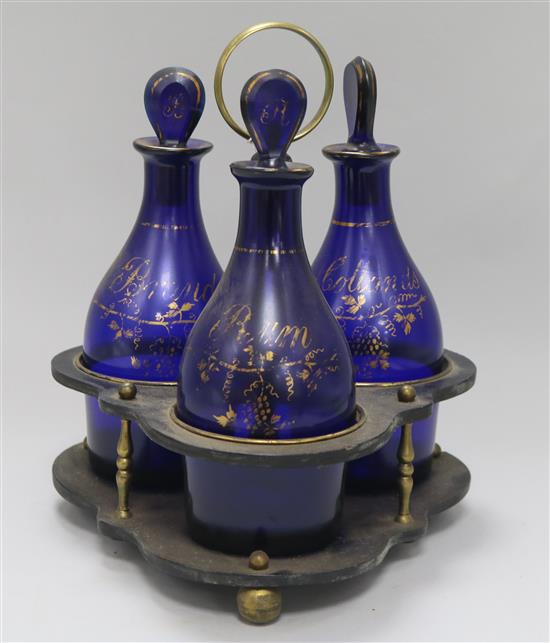 A Regency gilt and blue glass three bottle decanter stand, some wear